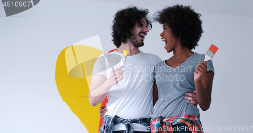 Image of couple with painted heart on wall