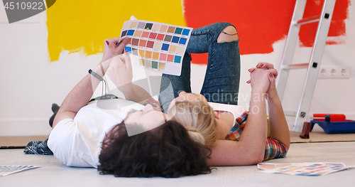 Image of Happy young couple relaxing after painting