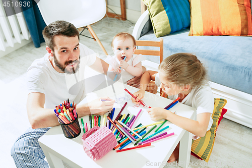 Image of father and his baby daughter at home