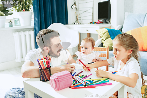 Image of father and his baby daughter at home