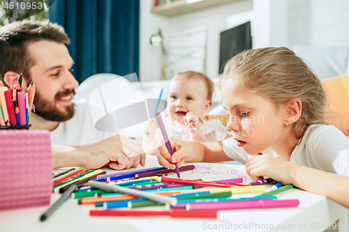 Image of father and his baby daughter at home