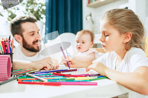 Image of father and his baby daughter at home