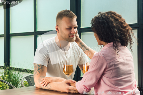 Image of She said him yes. Closeup of young man kissing his wife hand while making marriage proposal outdoors.