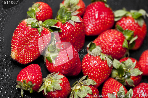 Image of Fresh ripe strawberry with water drops on black