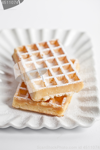 Image of Belgium waffers with sugar powder on ceramic plate isolated on w