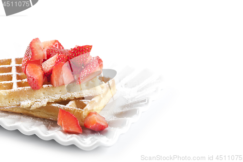 Image of Belgium waffers with sugar powder and strawberries on ceramic pl