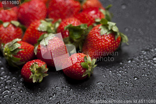Image of Fresh ripe strawberry with water drops closeup.