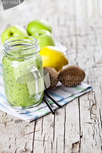 Image of Green smoothie with kiwi, apple, lemon and chia seeds. Healthy f