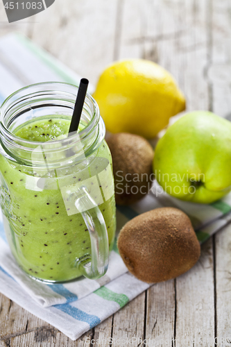 Image of Green smoothie with kiwi, apple, lemon and chia seeds. Healthy f