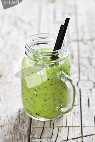 Image of Green smoothie with kiwi, apple, lime and linen seeds. Healthy f