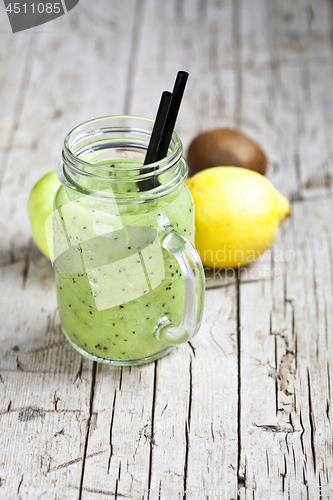 Image of Green smoothie with kiwi, apple, lemon and chia seeds. Healthy f