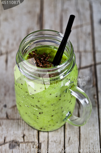 Image of Green smoothie with kiwi, apple, lime and linen seeds. Healthy f