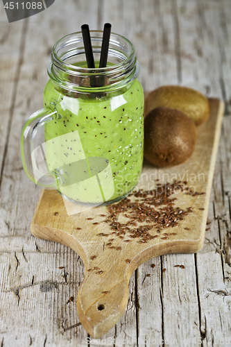 Image of Green smoothie with kiwi, apple, lemon and linen seeds. Healthy 