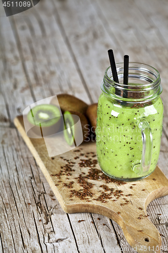 Image of Green smoothie with kiwi, apple, lemon and linen seeds. Healthy 