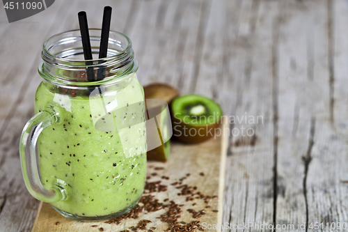 Image of Green smoothie with kiwi, apple, lemon and linen seeds. Healthy 