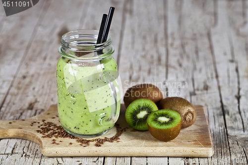 Image of Green smoothie with kiwi, apple, lemon and linen seeds. Healthy 