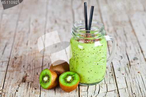 Image of Green smoothie with kiwi, apple, lemon and linen seeds. Healthy 