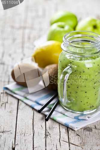 Image of Green smoothie with kiwi, apple, lemon and chia seeds. Healthy f