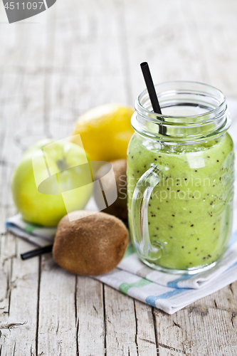 Image of Green smoothie with kiwi, apple, lemon and chia seeds. Healthy f