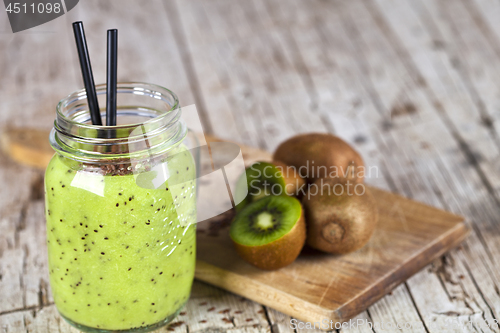 Image of Green smoothie with kiwi, apple, lemon and linen seeds. Healthy 