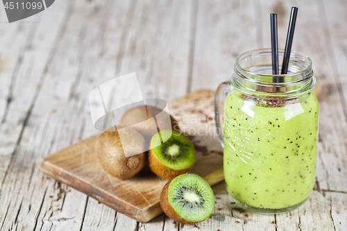 Image of Green smoothie with kiwi, apple, lemon and linen seeds. Healthy 