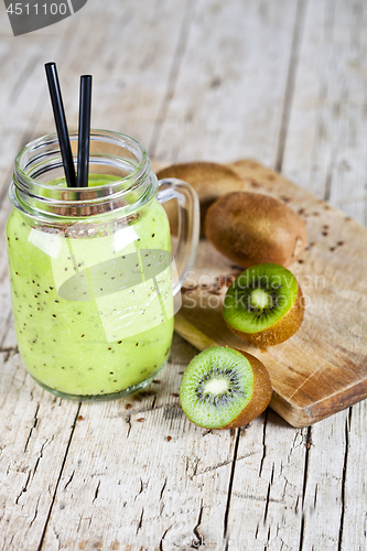 Image of Green smoothie with kiwi, apple, lemon and linen seeds. Healthy 