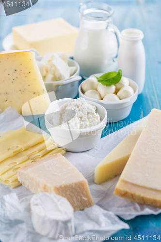 Image of Different types of dairy products on wooden background