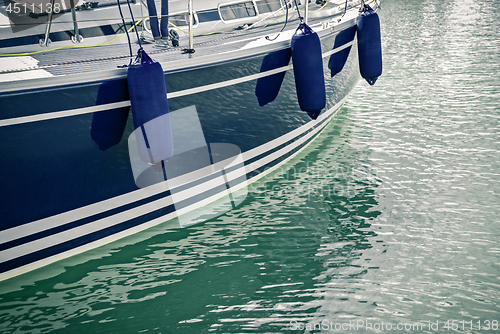 Image of Blue motorboat reflecting in water