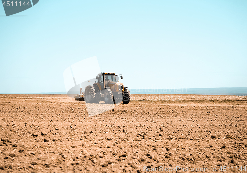 Image of Tractor plowing the land in spring