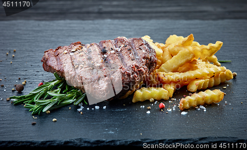 Image of grilled beef fillet steak and fried potatoes