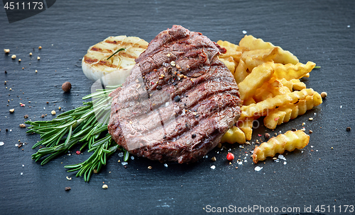 Image of grilled beef fillet steak and fried potatoes