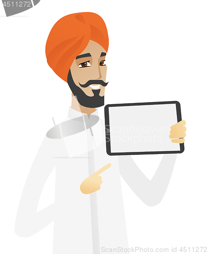 Image of Hindu businessman holding tablet computer.