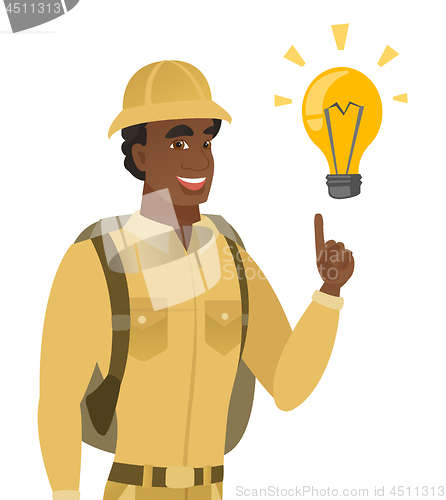 Image of African-american traveler pointing at light bulb.