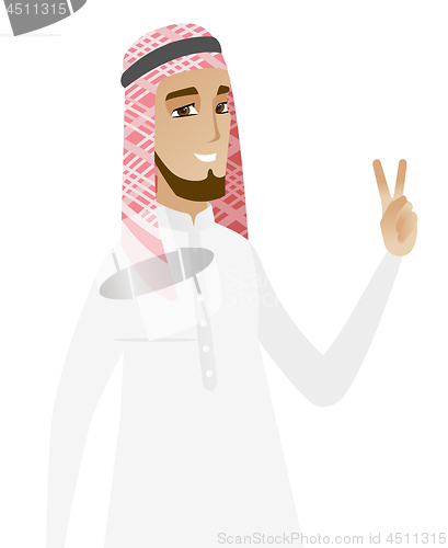 Image of Muslim businessman showing victory gesture.
