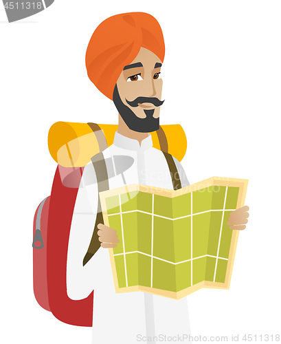 Image of Hindu traveler with backpack looking at map.