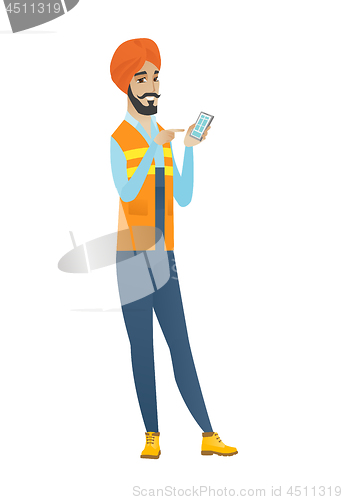Image of Young hindu builder holding a mobile phone.