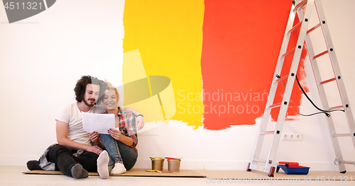 Image of Happy young couple relaxing after painting