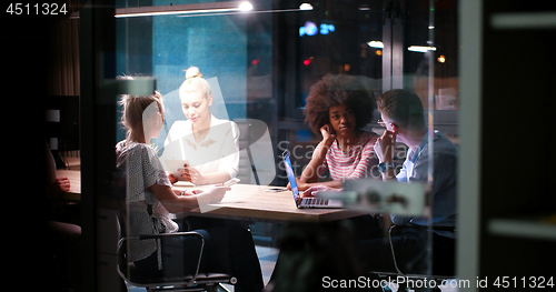 Image of Multiethnic startup business team in night office