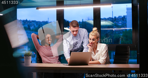 Image of Multiethnic startup business team in night office