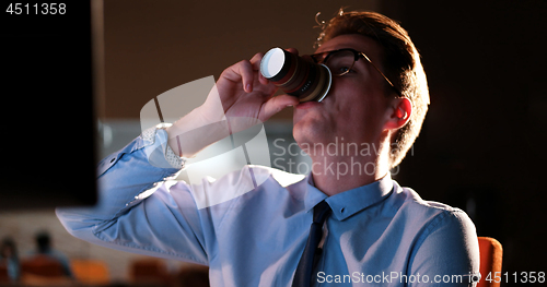 Image of Tired businessman working late