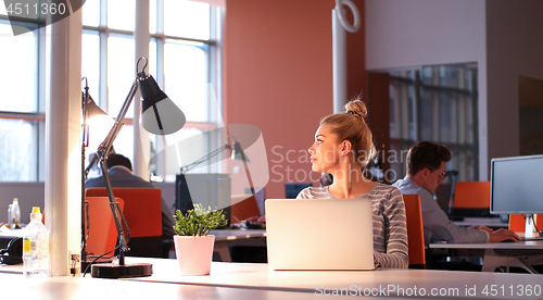 Image of businesswoman using a laptop in startup office