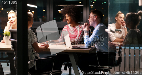 Image of Multiethnic startup business team in night office