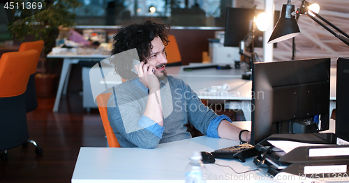 Image of businessman working using a computer in startup office