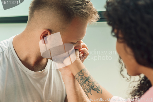 Image of She said him yes. Closeup of young man kissing his wife hand while making marriage proposal outdoors.