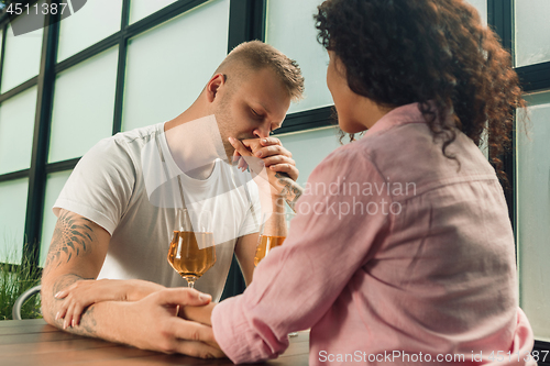 Image of She said him yes. Closeup of young man kissing his wife hand while making marriage proposal outdoors.