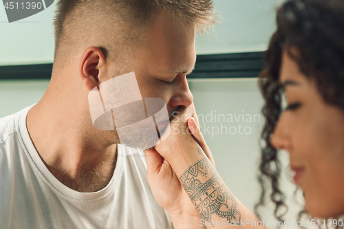 Image of She said him yes. Closeup of young man kissing his wife hand while making marriage proposal outdoors.