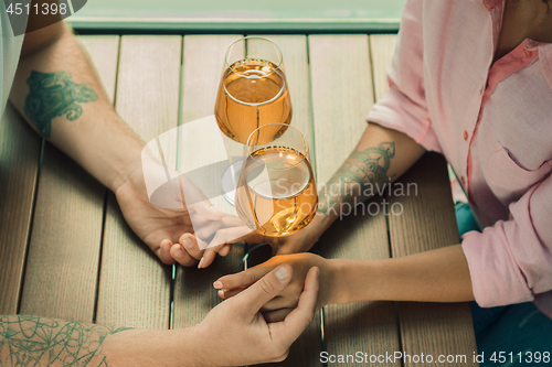 Image of She said him yes. Closeup of young man kissing his wife hand while making marriage proposal outdoors.