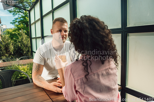 Image of She said him yes. Closeup of young man kissing his wife hand while making marriage proposal outdoors.