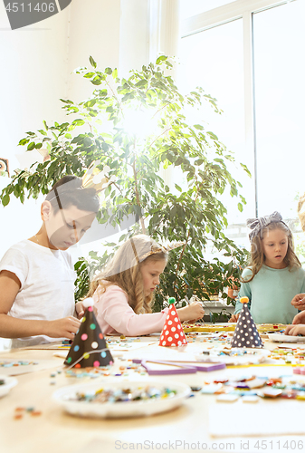 Image of mosaic puzzle art for kids, children\'s creative game. two sisters are playing mosaic