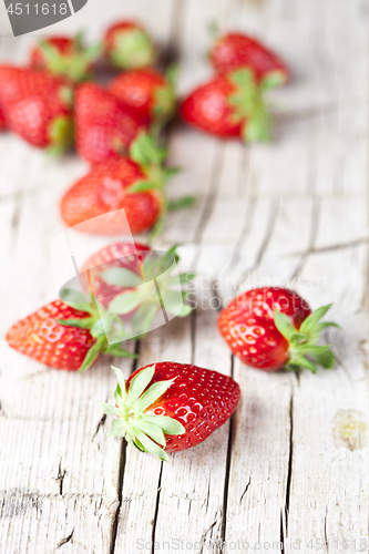 Image of Fresh red strawberries on rustic wooden background. 